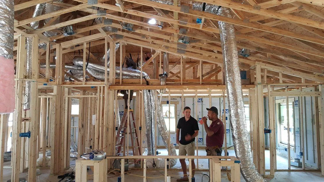 Flexible ductwork being installed in a house under construction