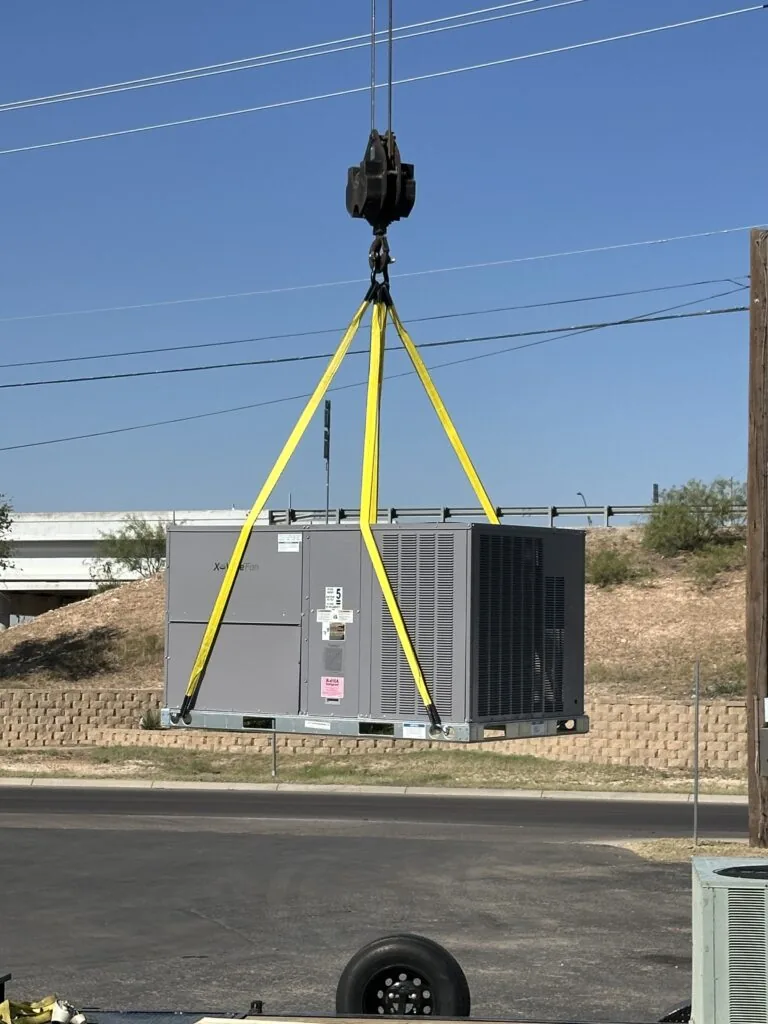 Packaged HVAC unit lifted by a Larry Pepper's crane