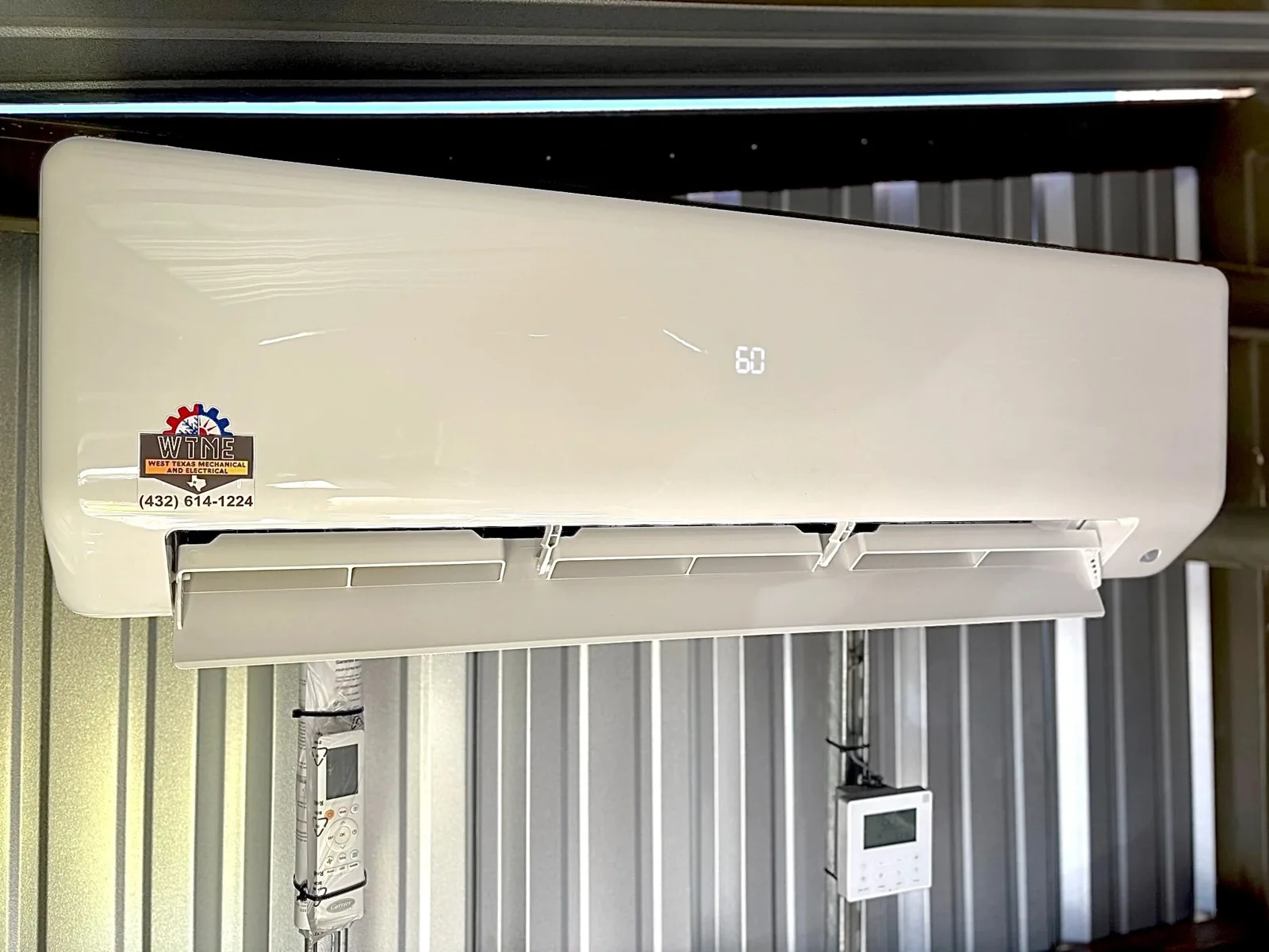 Ductless wall unit installed by West Texas Mechanical & Electrical, with the company sticker