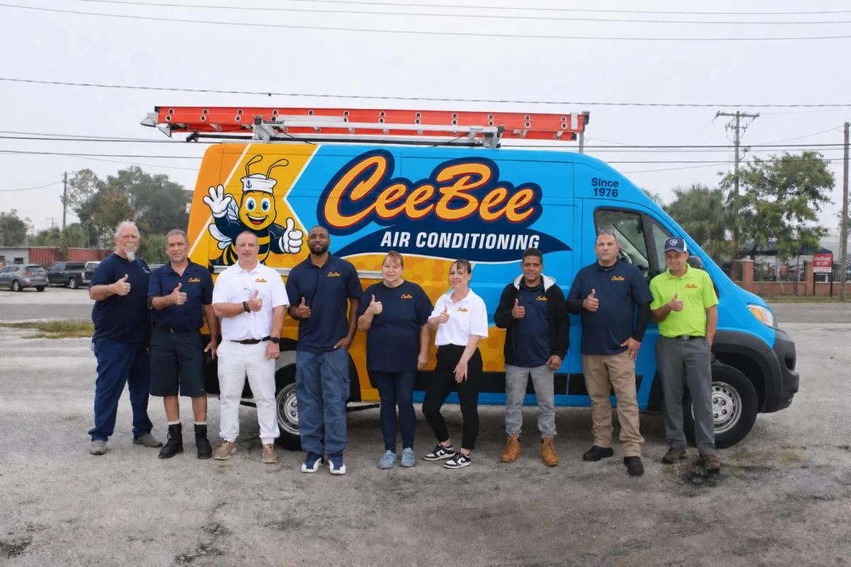 CeeBee Air Conditioning staff lined up in front of a branded company van