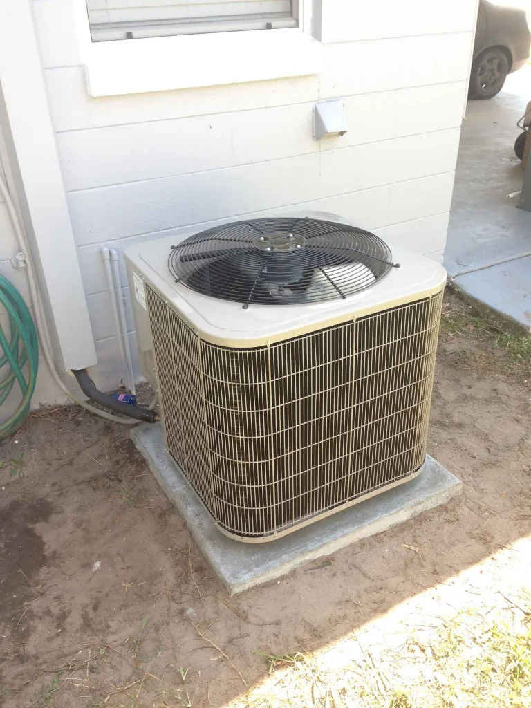 Newly installed condenser on a concrete pad, from the company installation photos