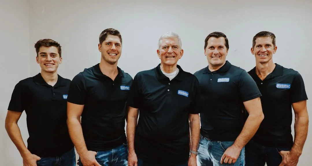 Webster family members of several generations in company shirts