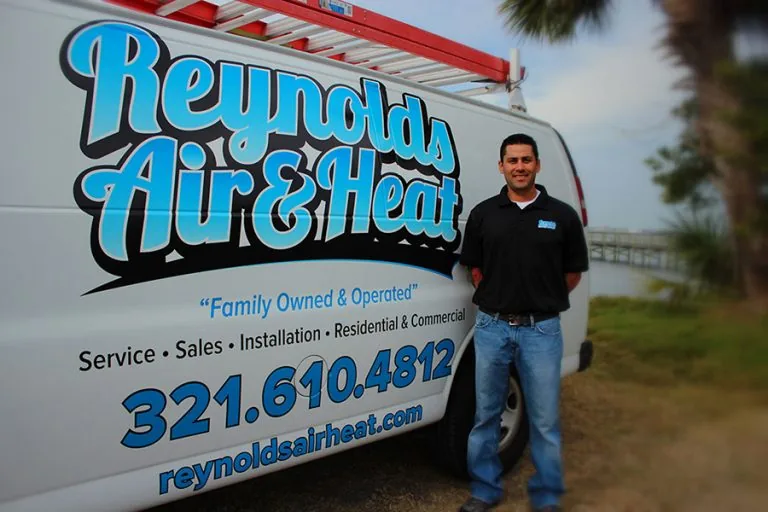 Owner Zach Reynolds beside a Reynolds Air & Heat van