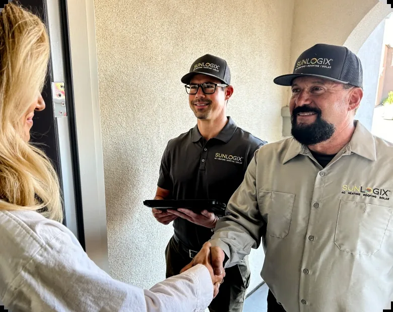 Two Sunlogix technicians greeting a customer at the door