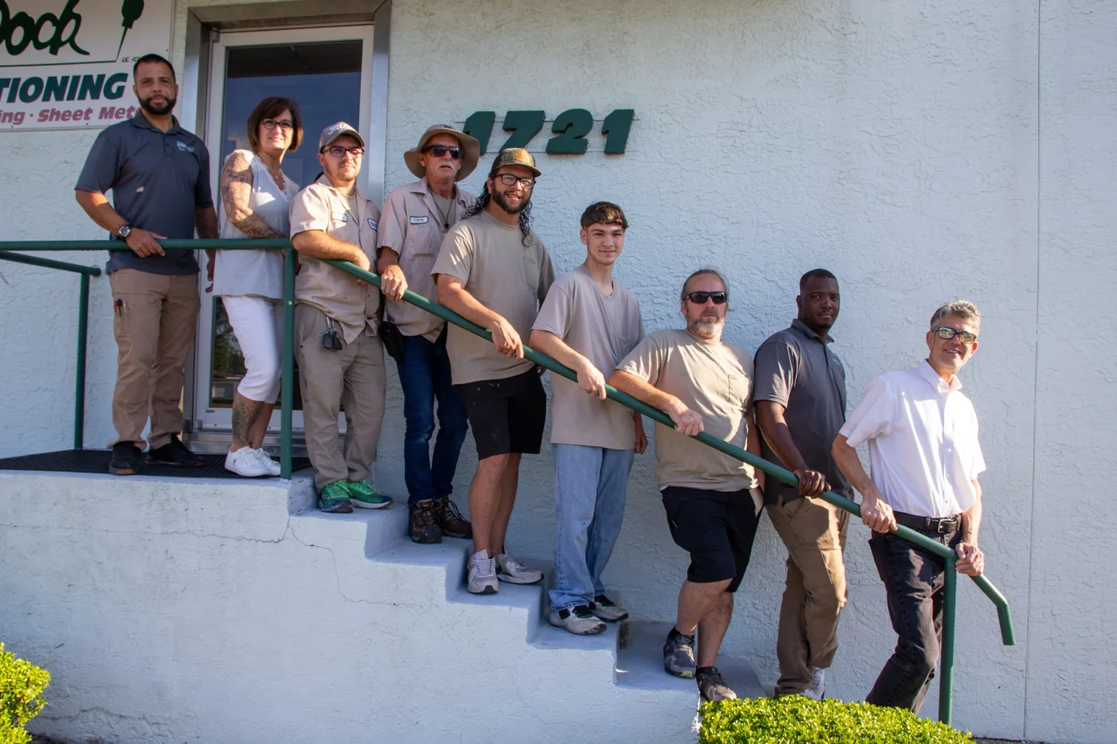 Tarpon Dock Air Conditioning team on the steps of its East 11th Street building