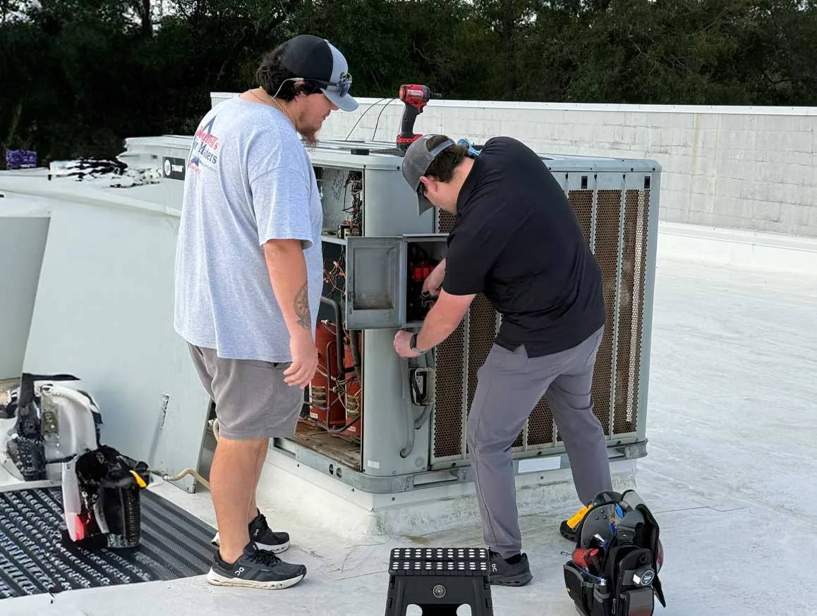 Boutwell's Air Masters technicians servicing a rooftop unit