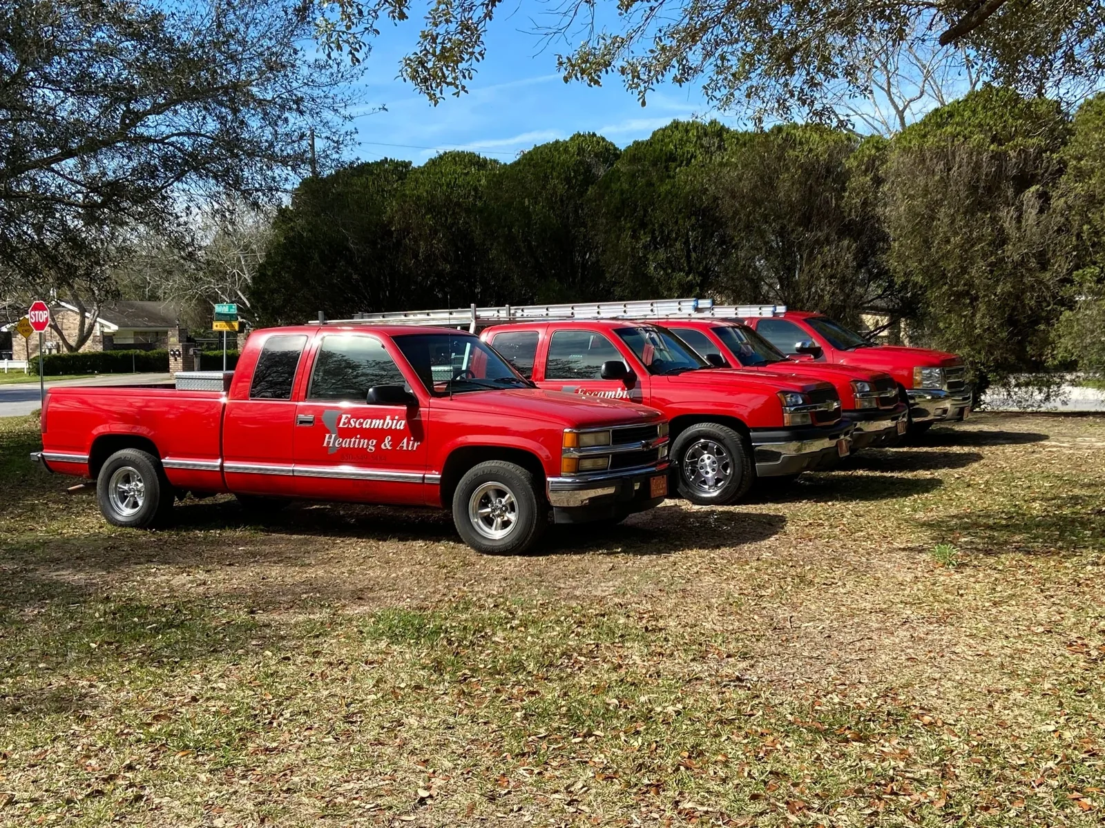 Escambia Heating & Air's red service trucks