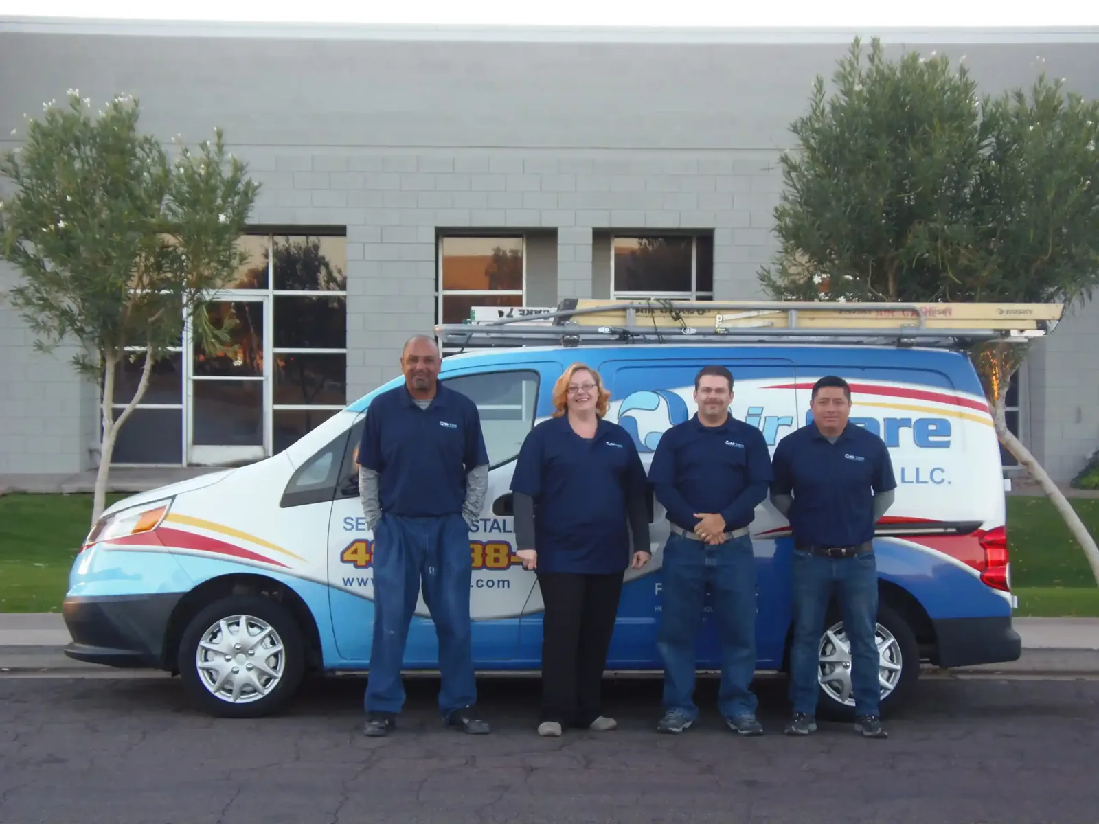 Air Care Cooling & Heating team with a company van outside the Mesa office