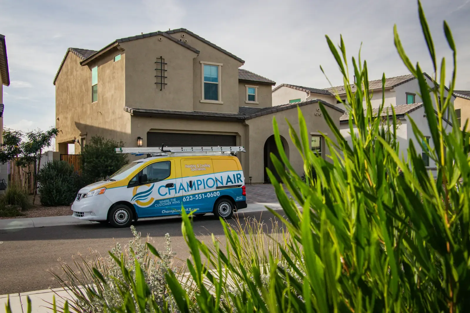 Champion Air service van parked at a home