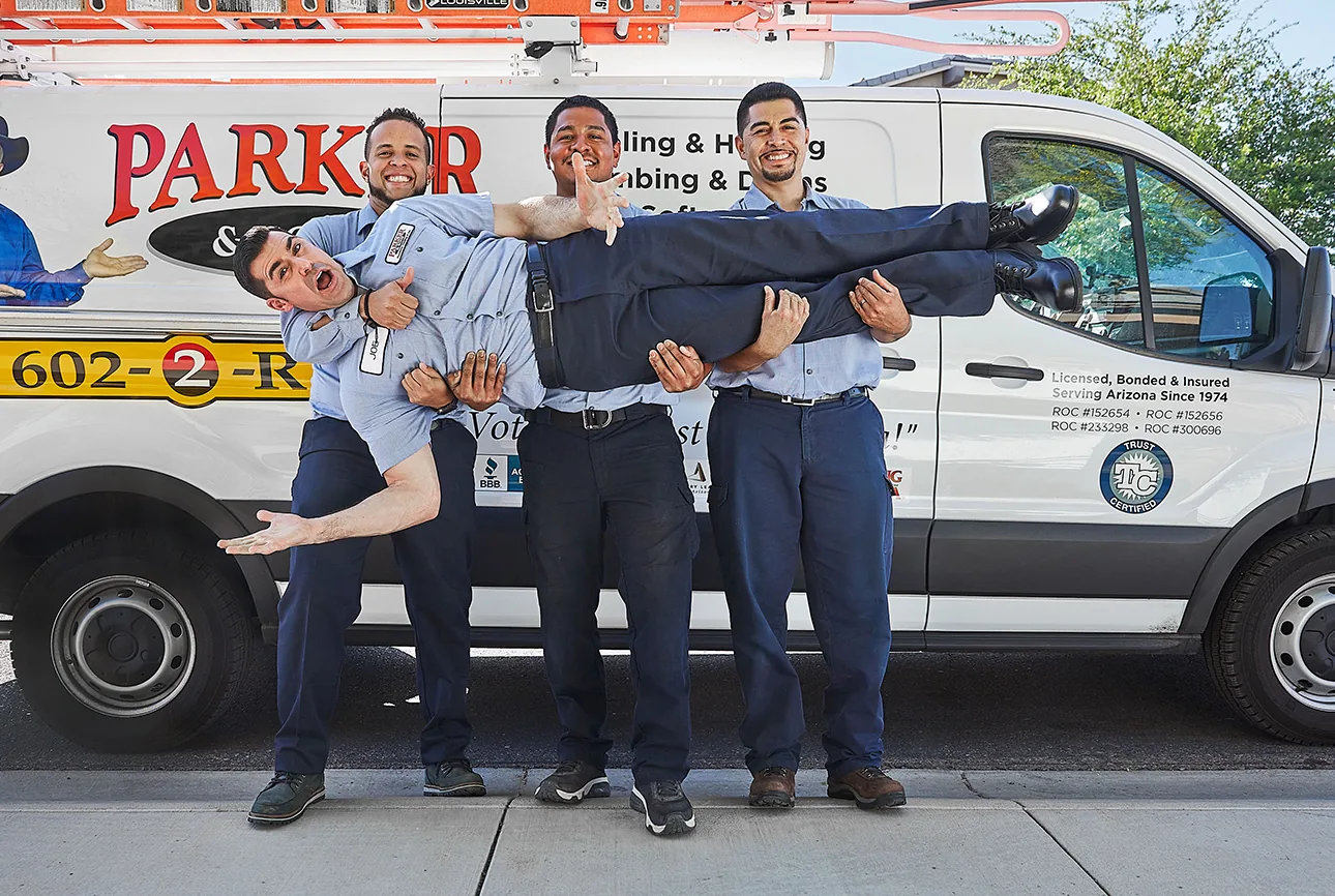 Parker & Sons technicians posing with a company van