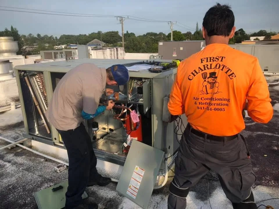 First Charlotte technicians working on a rooftop unit