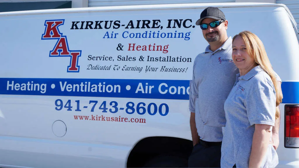 Kirkus Aire owners beside a company van