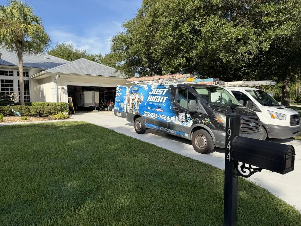 Just Right Heating & Cooling service vans parked at a home