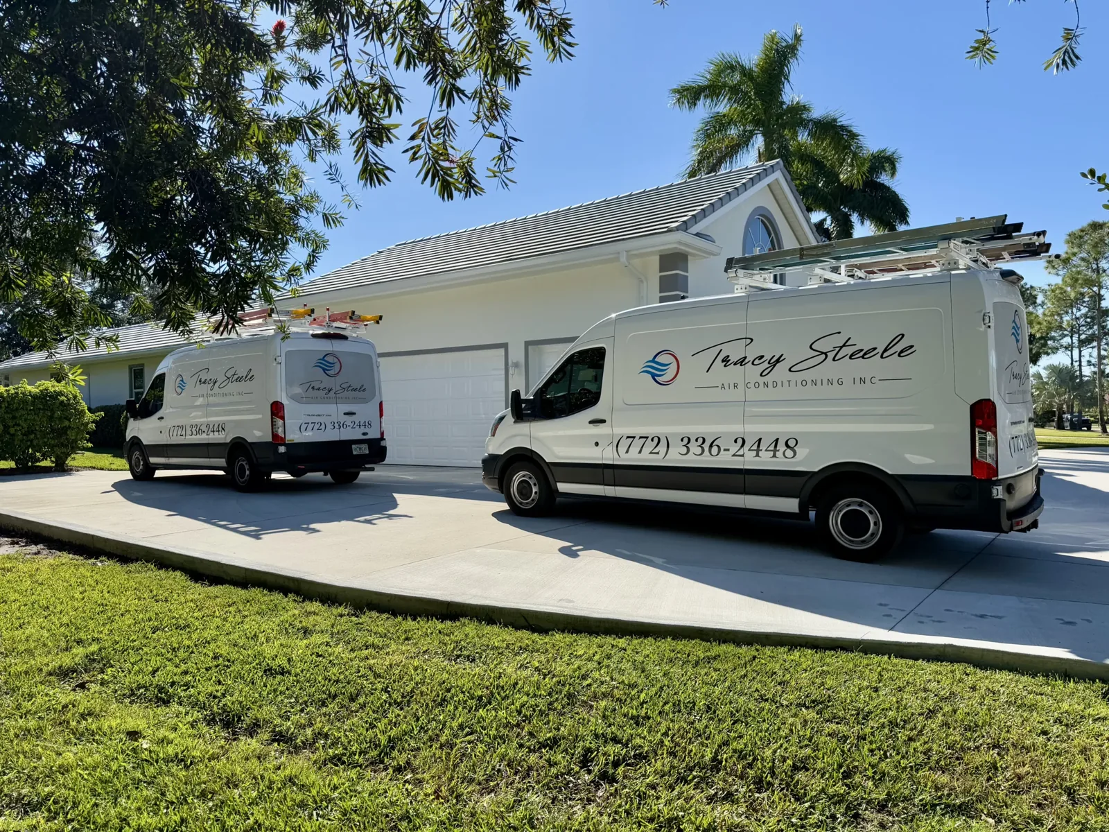 Tracy Steele Air Conditioning service vans parked at a home