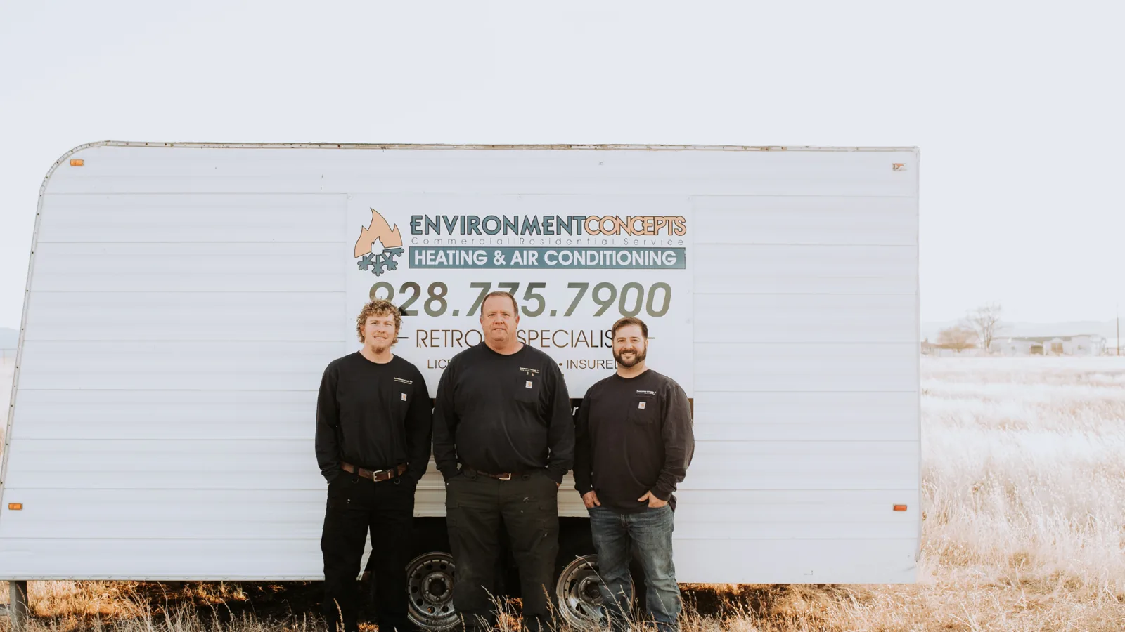 Three Environment Concepts technicians in front of the company trailer