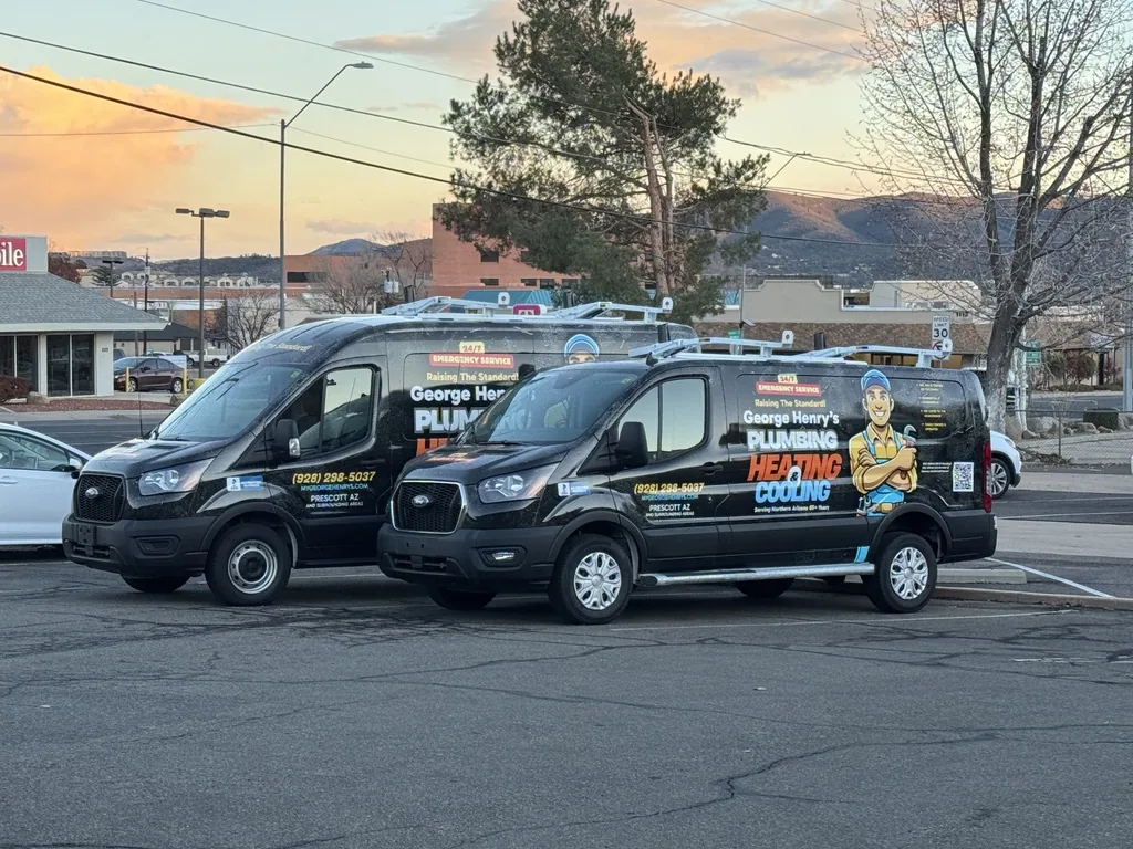 Two George Henry's service vans parked in Prescott