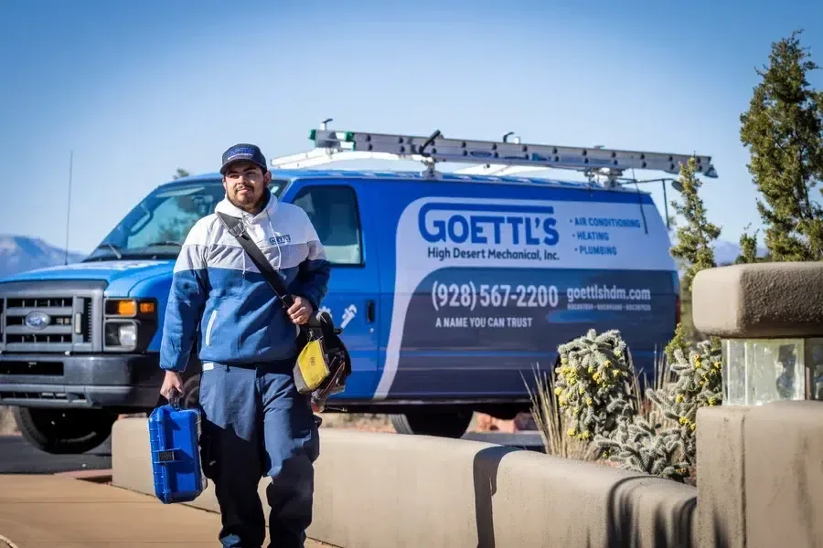 Goettl's High Desert Mechanical technician walking from a company van