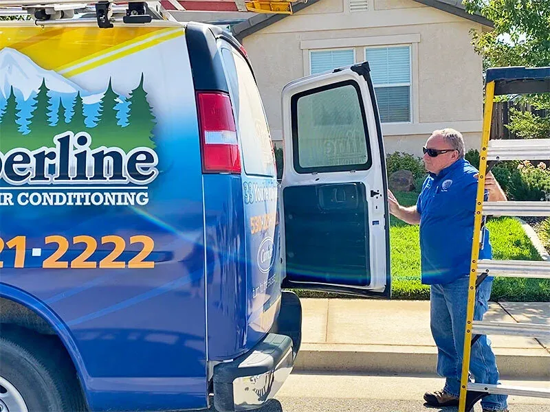 Timberline technician unloading a ladder from a company van