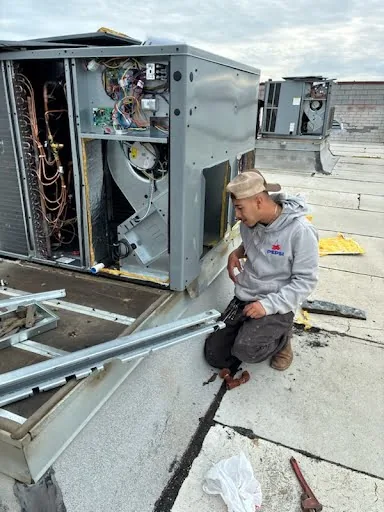 All HVAC Services technician working on a rooftop package unit at a Sacramento job