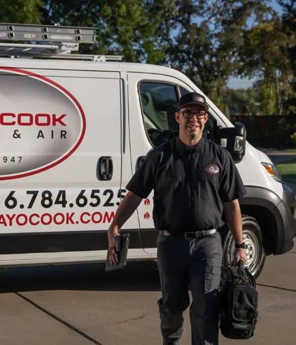 Ray O. Cook technician walking from a company service van