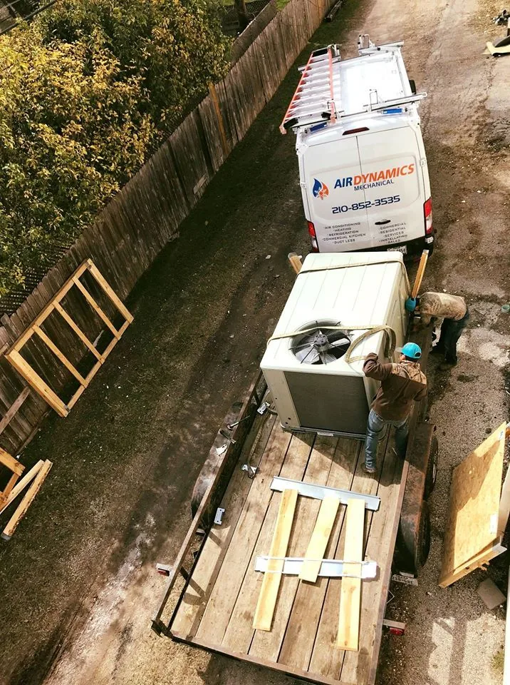 Air Dynamics Mechanical van and a new outdoor unit on a job site