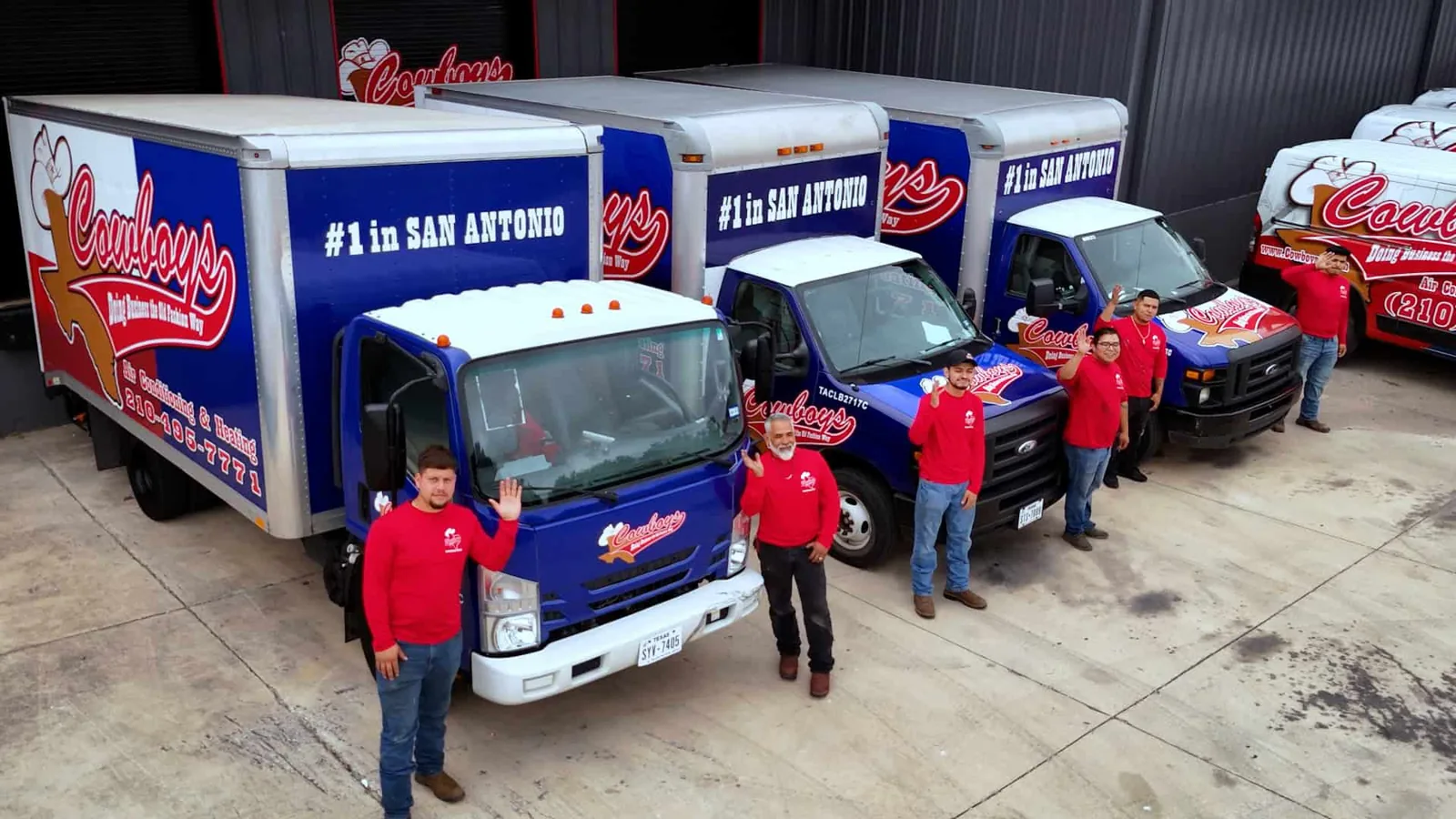 Cowboy's crew in red shirts with the company's box trucks
