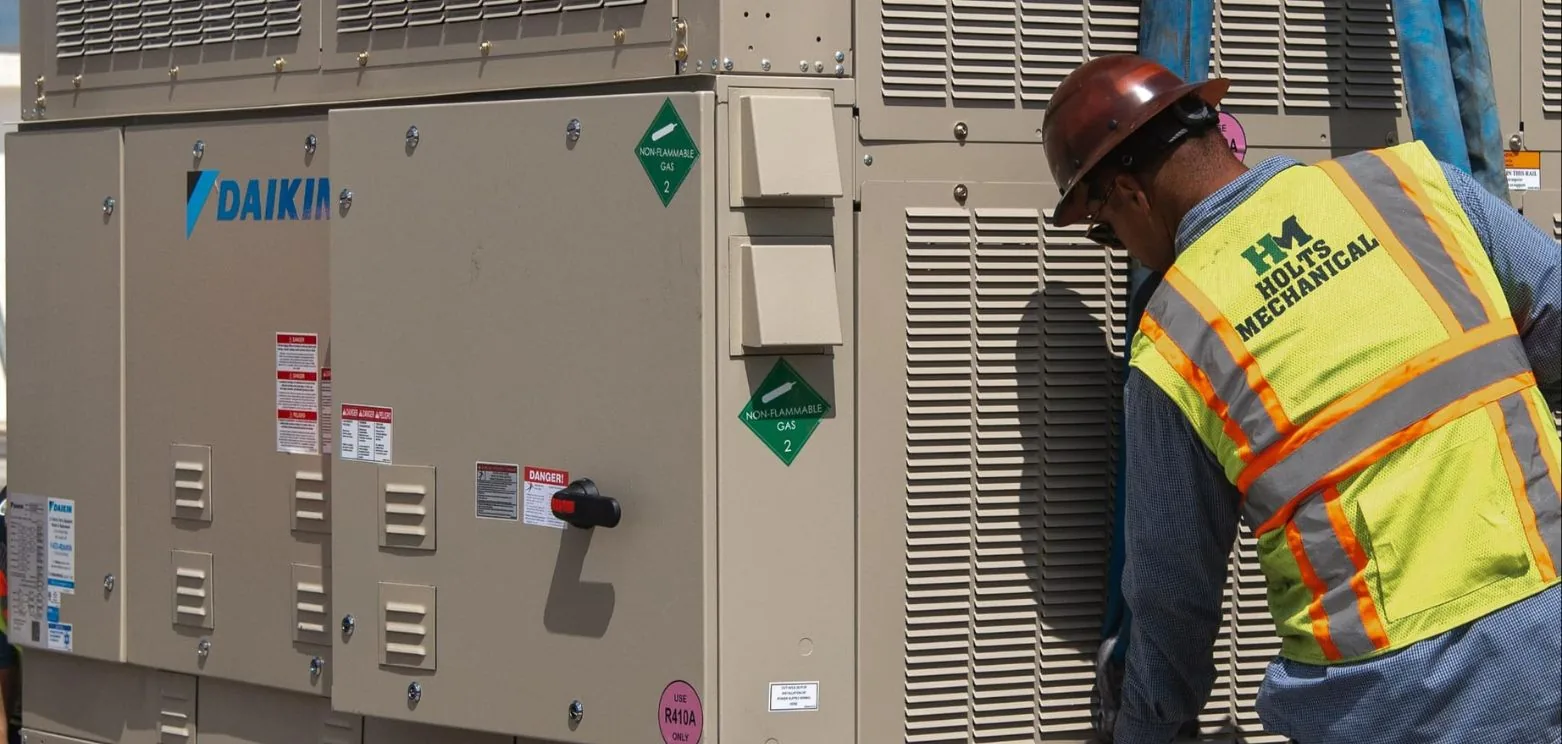Holts Mechanical technician servicing a commercial rooftop unit