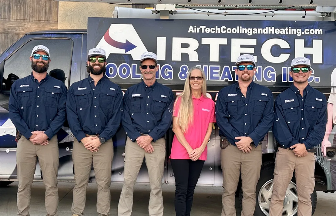 Airtech Cooling & Heating team in front of a branded company vehicle