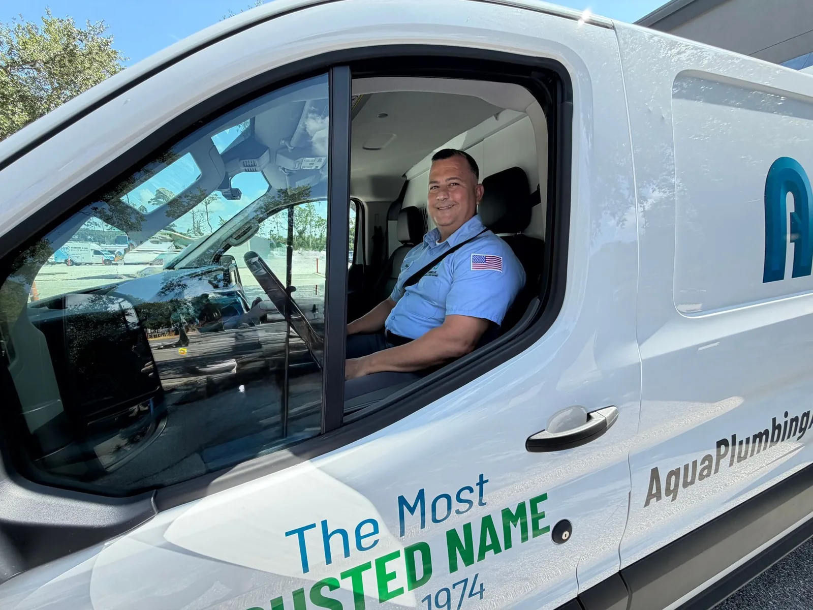 Aqua Plumbing & Air technician in a company van