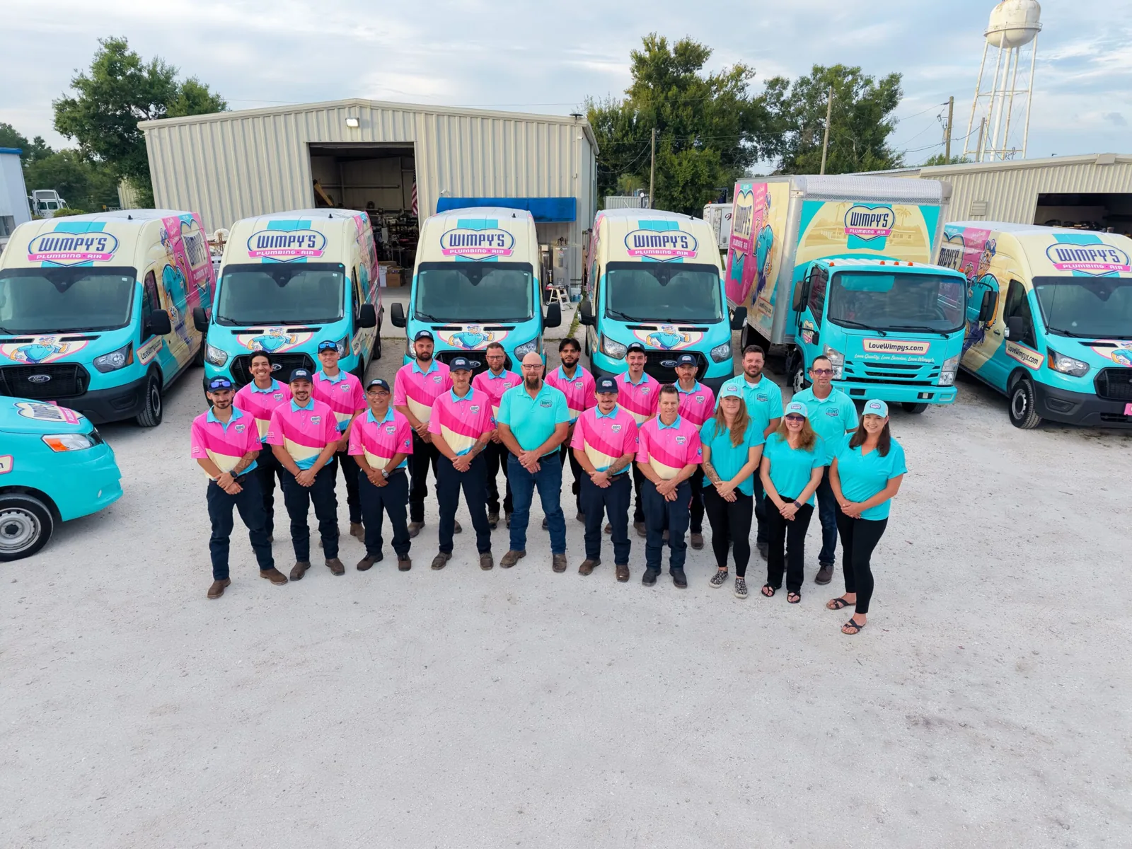 Wimpy's Plumbing & Air team in front of the company's service vans