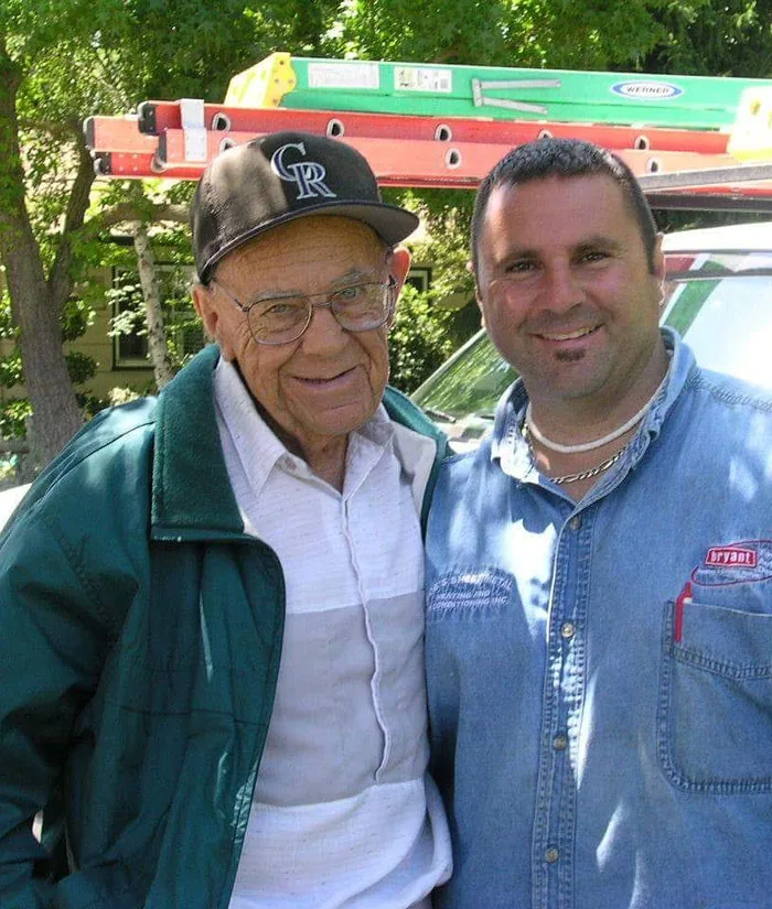 Photo labelled 'Bob Sr.' on the Queirolo's website: two men in front of a work truck with ladders