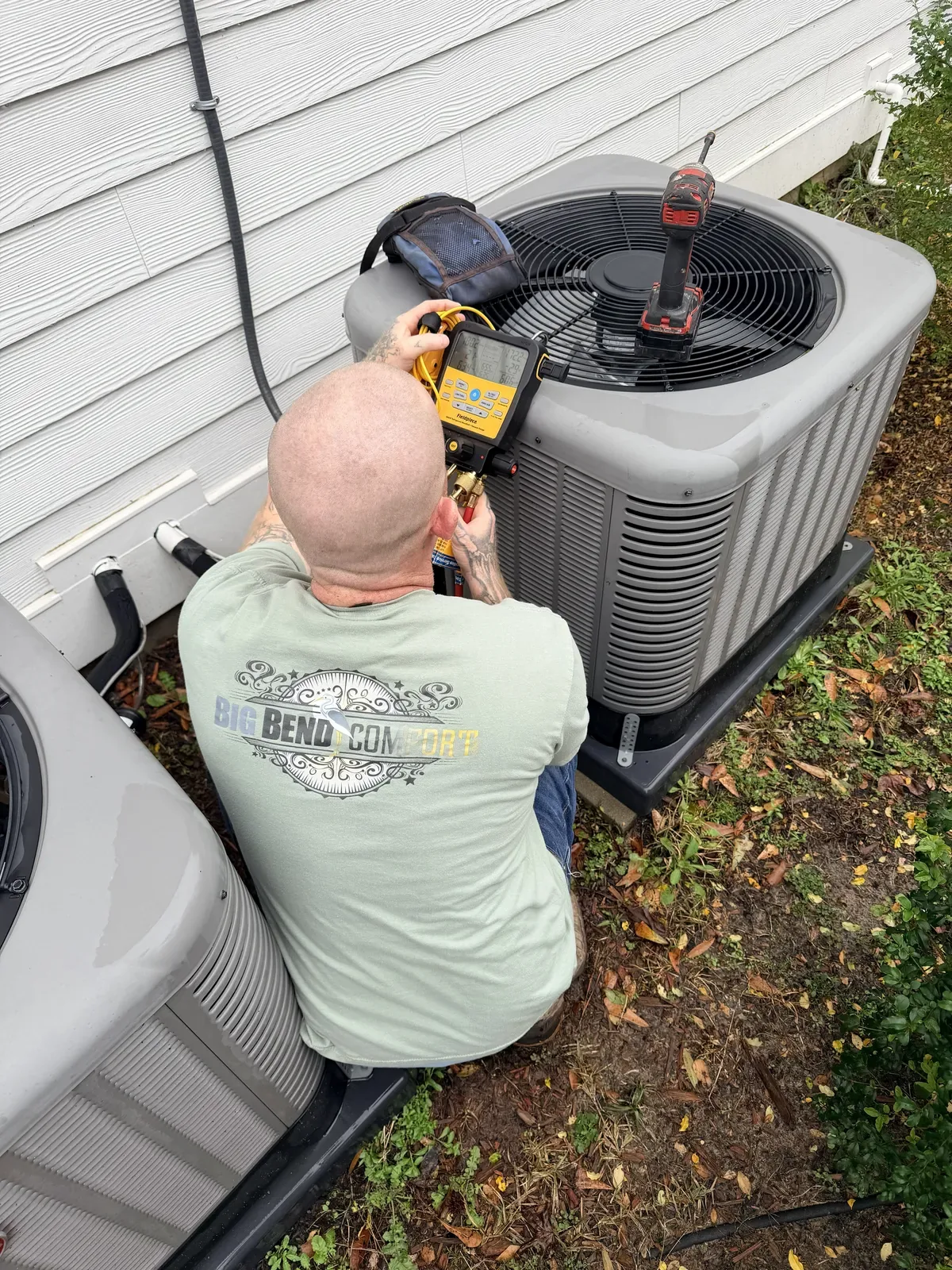 Big Bend Comfort technician testing an outdoor AC unit