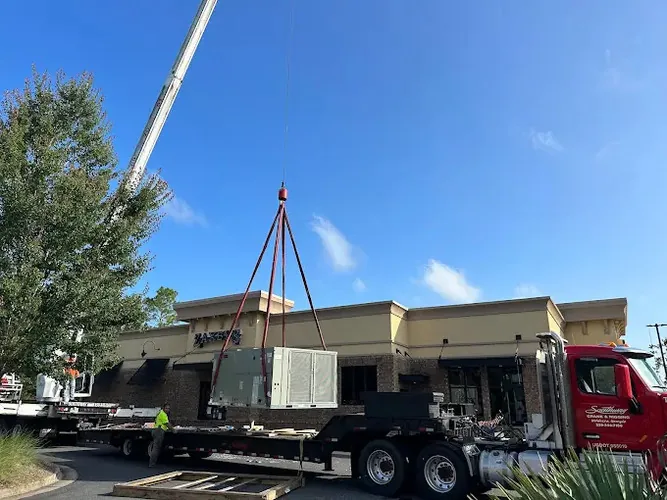 Commercial rooftop HVAC unit being lifted by crane on a Noble Air Solutions job
