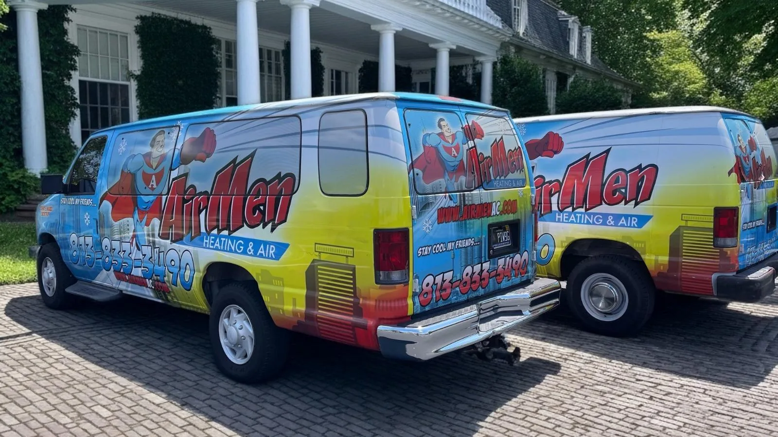Two AirMen Heating & Air vans in their branded wrap