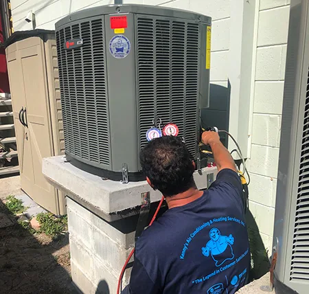 Kenny's technician checking refrigerant pressures on an outdoor unit
