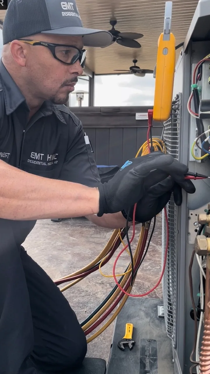 EMT-HVAC technician testing wiring in an air handler