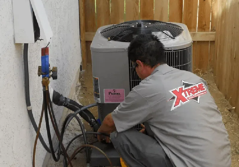 XTREME technician working on an outdoor AC condenser