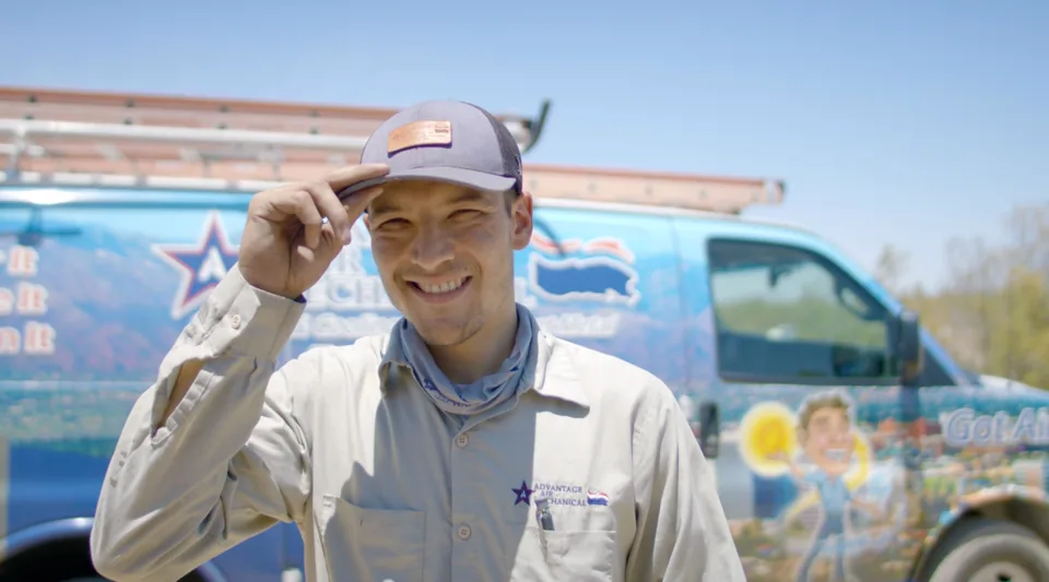 Advantage Air Mechanical technician in front of a company van