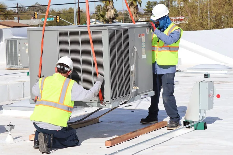 Ultra Air Conditioning technicians setting a new rooftop AC unit