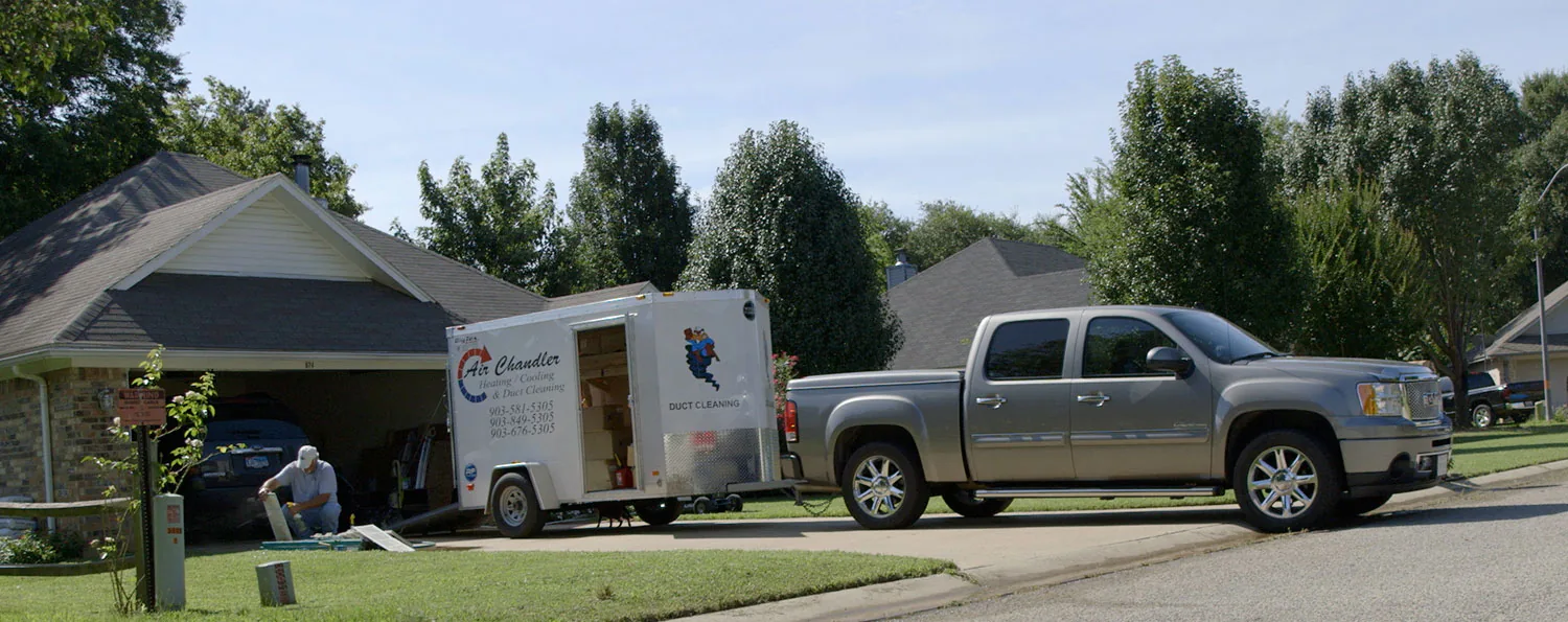 Air Chandler duct cleaning trailer and truck at a customer home