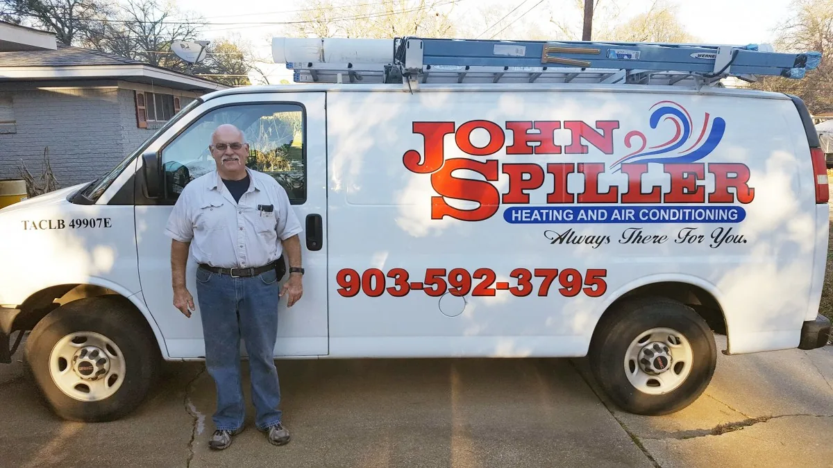 John Spiller Heating and Air Conditioning service van with its license number on the door
