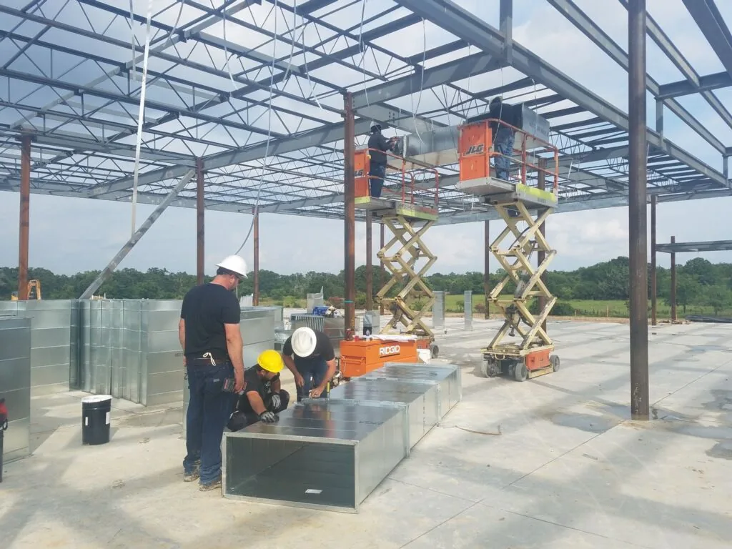 Velocity Mechanical crew assembling ductwork on a commercial building site