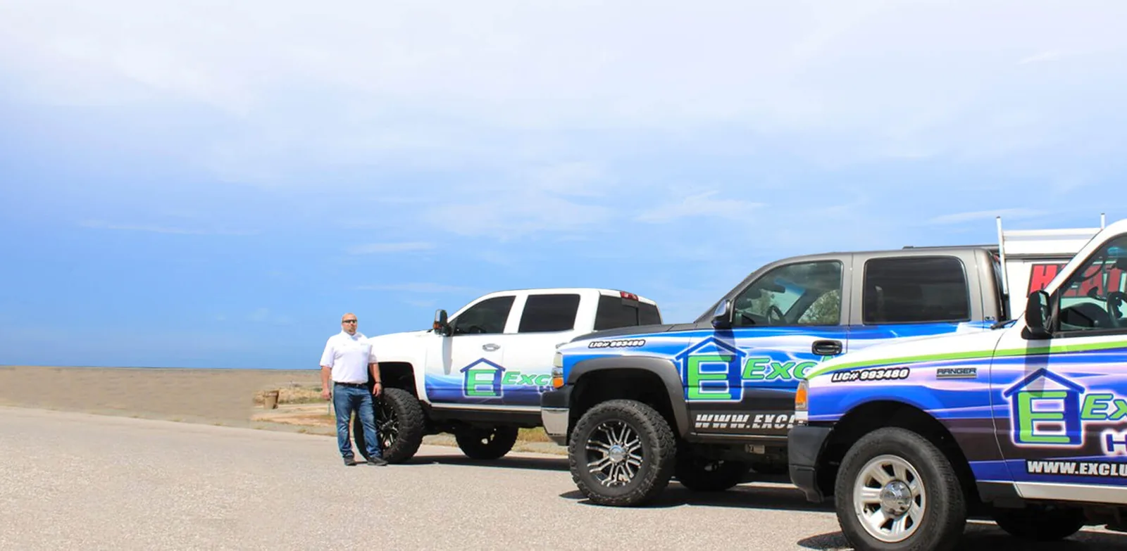 Exclusive HVAC service trucks lined up with a team member