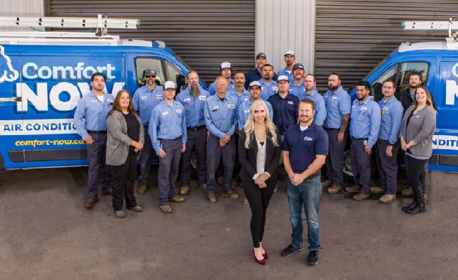 Comfort Now team standing between two company vans