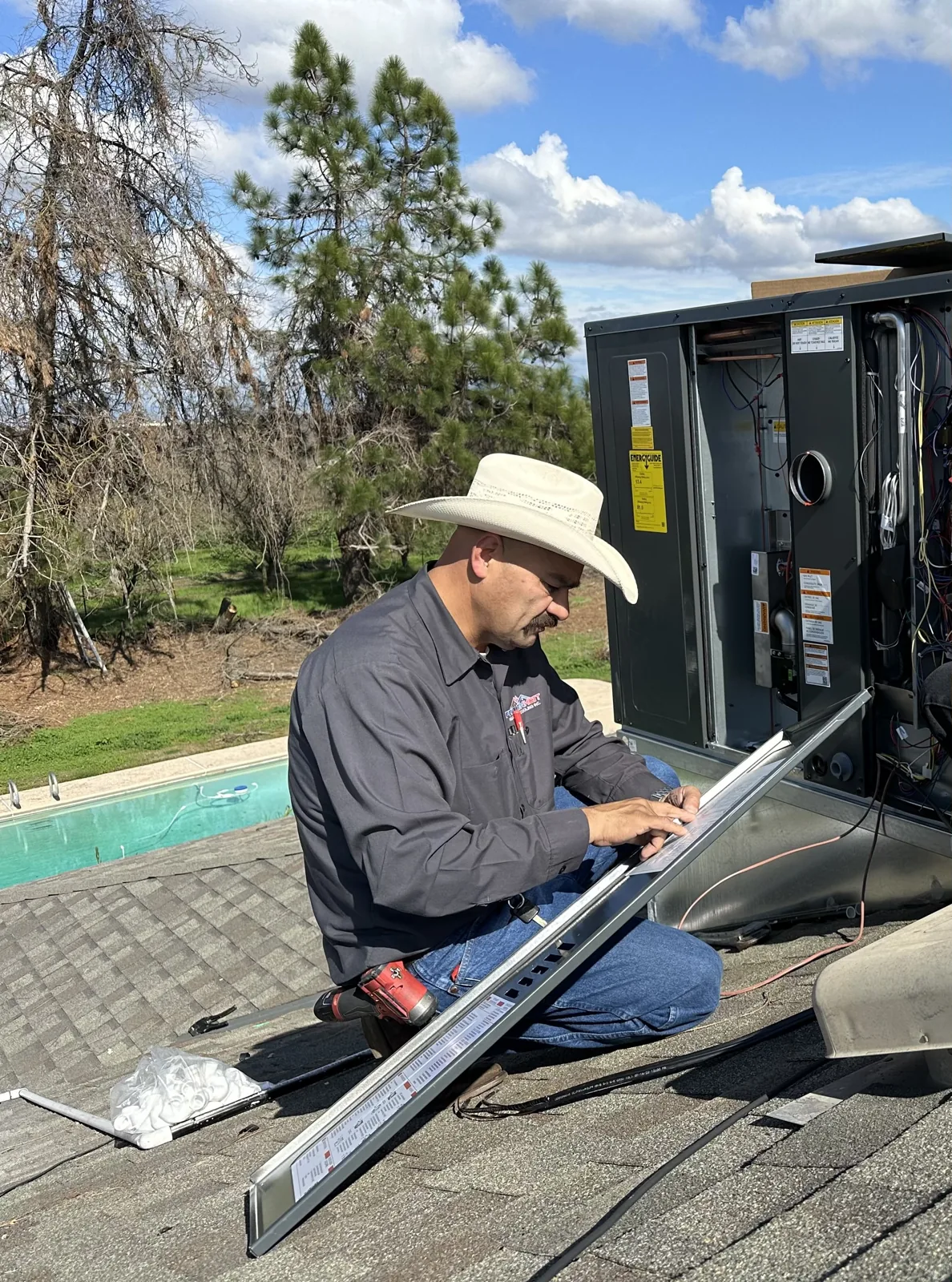Fahrenheit Heating & Cooling technician working on a rooftop unit