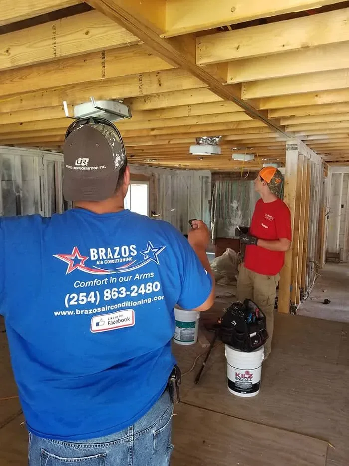 Brazos Air Conditioning technician on a job