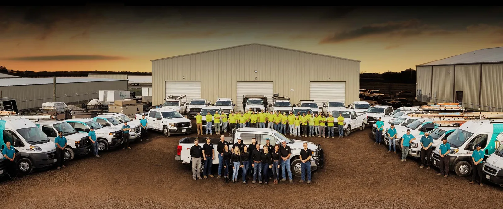 P&E Mechanical staff and service vans in front of the Waco shop