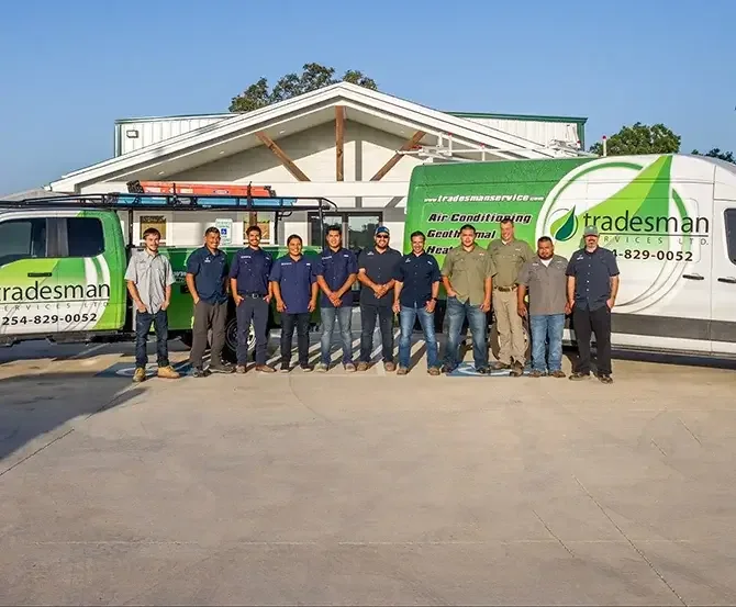 Tradesman Services crew lined up beside the company service vans